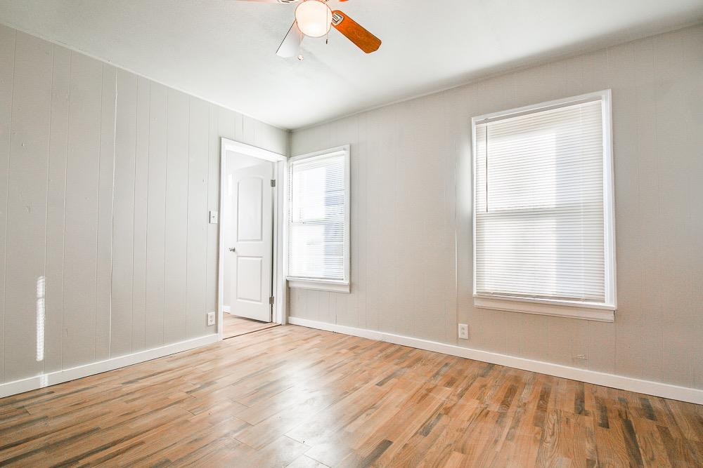 5705 County Road 1200 Lubbock, TX 79407 - Photo 16 of 29 an empty room with wooden floor and windows