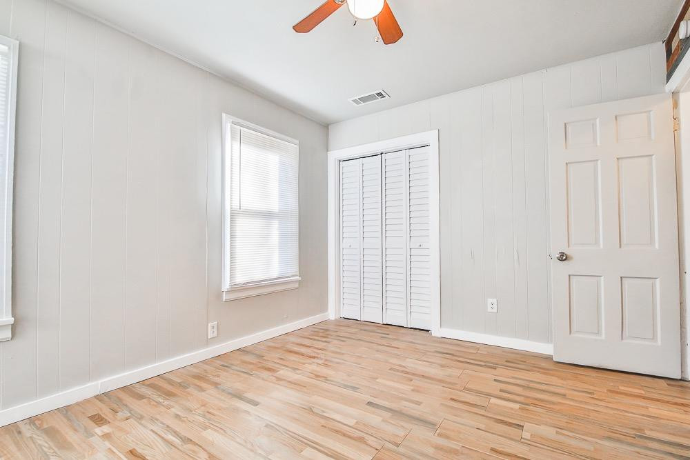 5705 County Road 1200 Lubbock, TX 79407 - Photo 17 of 29 a view of an empty room with wooden floor and a window