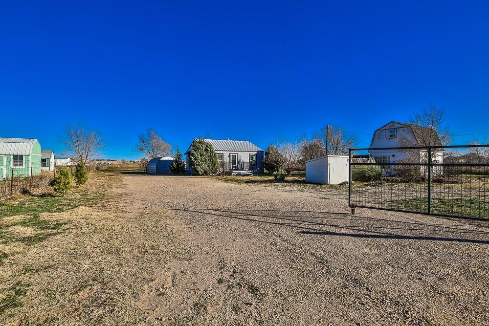 5705 County Road 1200 Lubbock, TX 79407 - Photo 2 of 29 a view of a house with a yard
