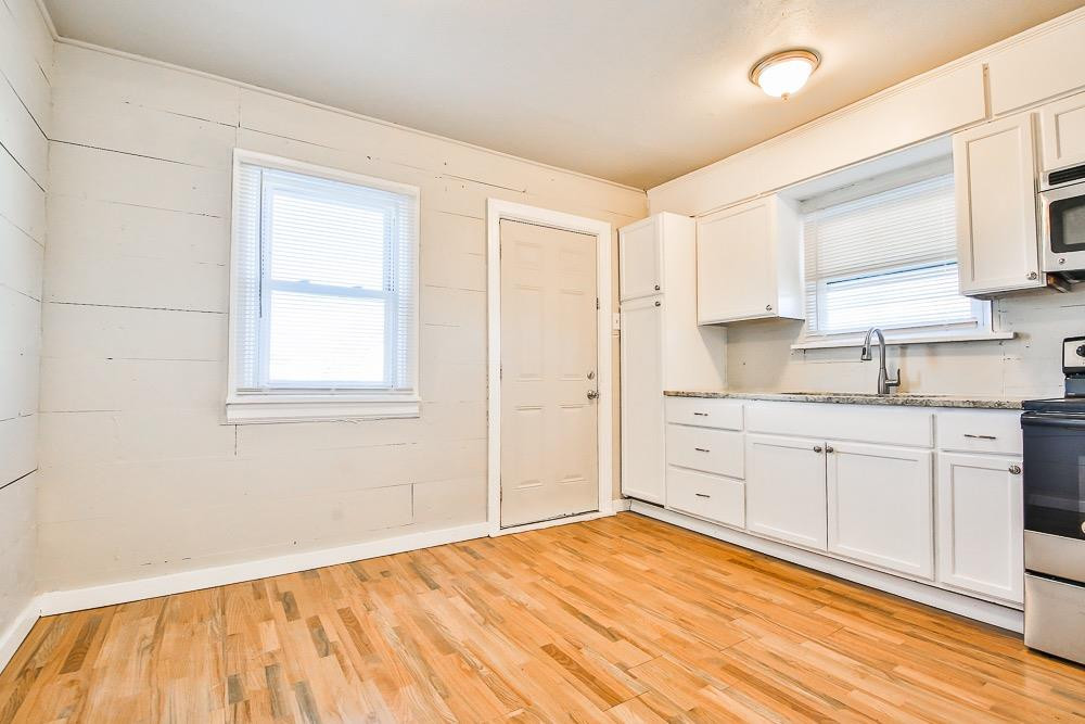 5705 County Road 1200 Lubbock, TX 79407 - Photo 23 of 29 a spacious bathroom with a granite countertop sink and a window