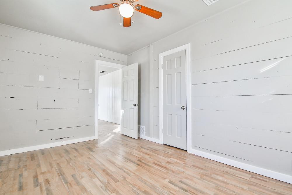 5705 County Road 1200 Lubbock, TX 79407 - Photo 27 of 29 an empty room with wooden floor and closet