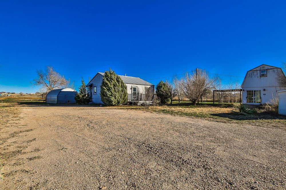 5705 County Road 1200 Lubbock, TX 79407 - Photo 3 of 29 a view of a house with a yard