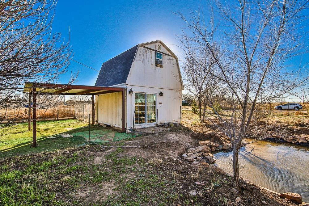 5705 County Road 1200 Lubbock, TX 79407 - Photo 9 of 29 a view of a house with a yard