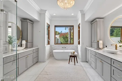 a bathroom with a granite countertop bathtub and sink