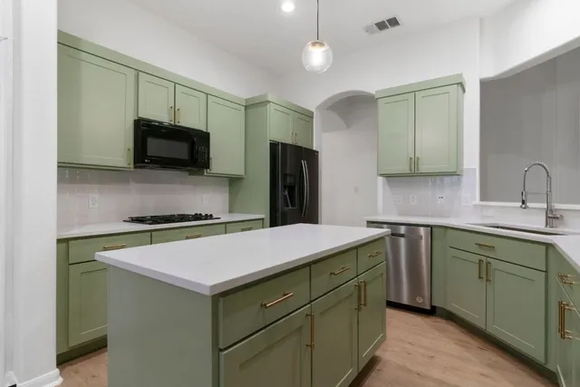 a kitchen with a sink and a refrigerator