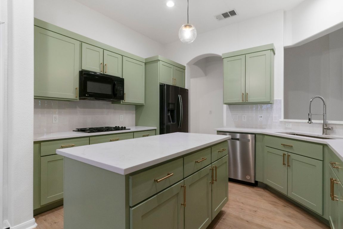 1333 Clary Sage Loop Round Rock, TX 78665 - Photo 12 of 35 a kitchen with a sink and a refrigerator