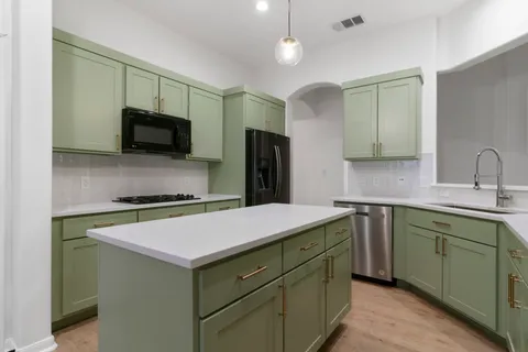 a kitchen with a sink and a refrigerator
