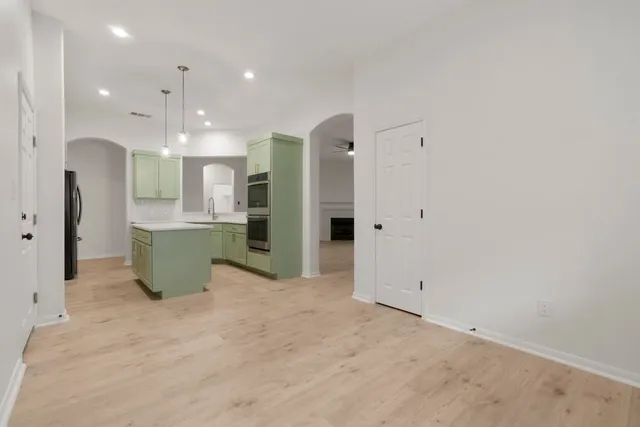 a view of kitchen with refrigerator and window