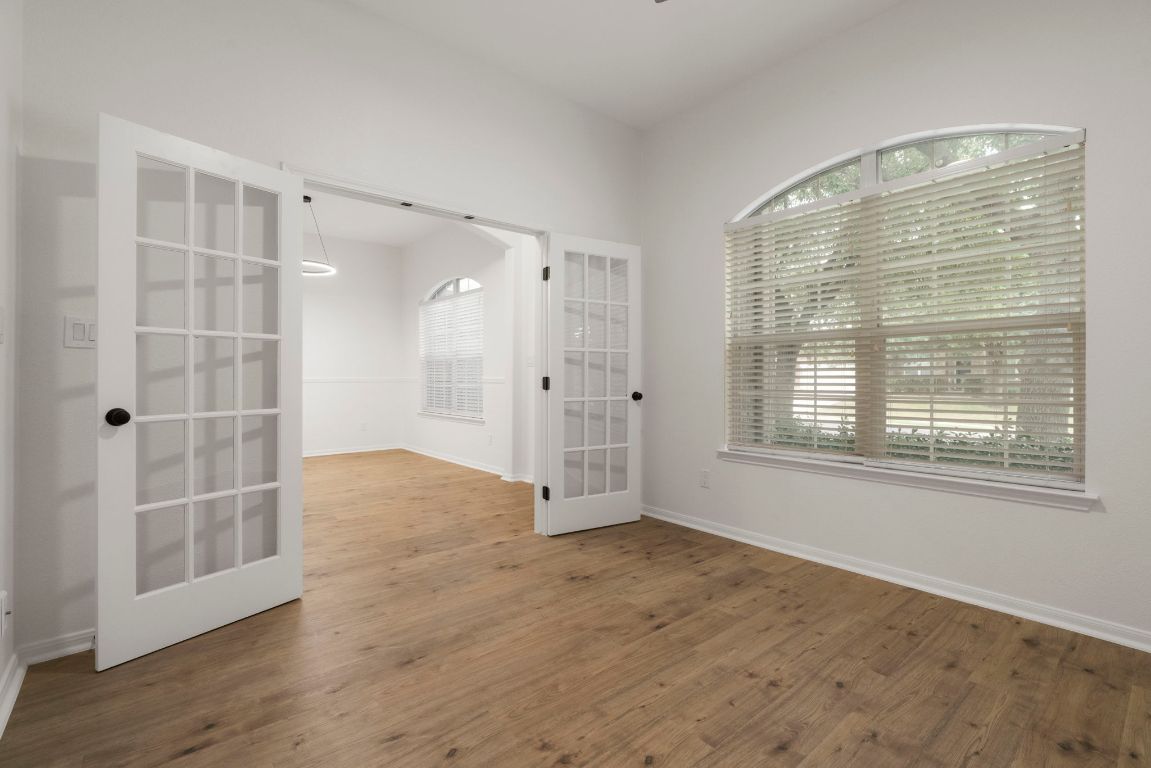 1333 Clary Sage Loop Round Rock, TX 78665 - Photo 19 of 35 a view of an empty room with wooden floor and windows
