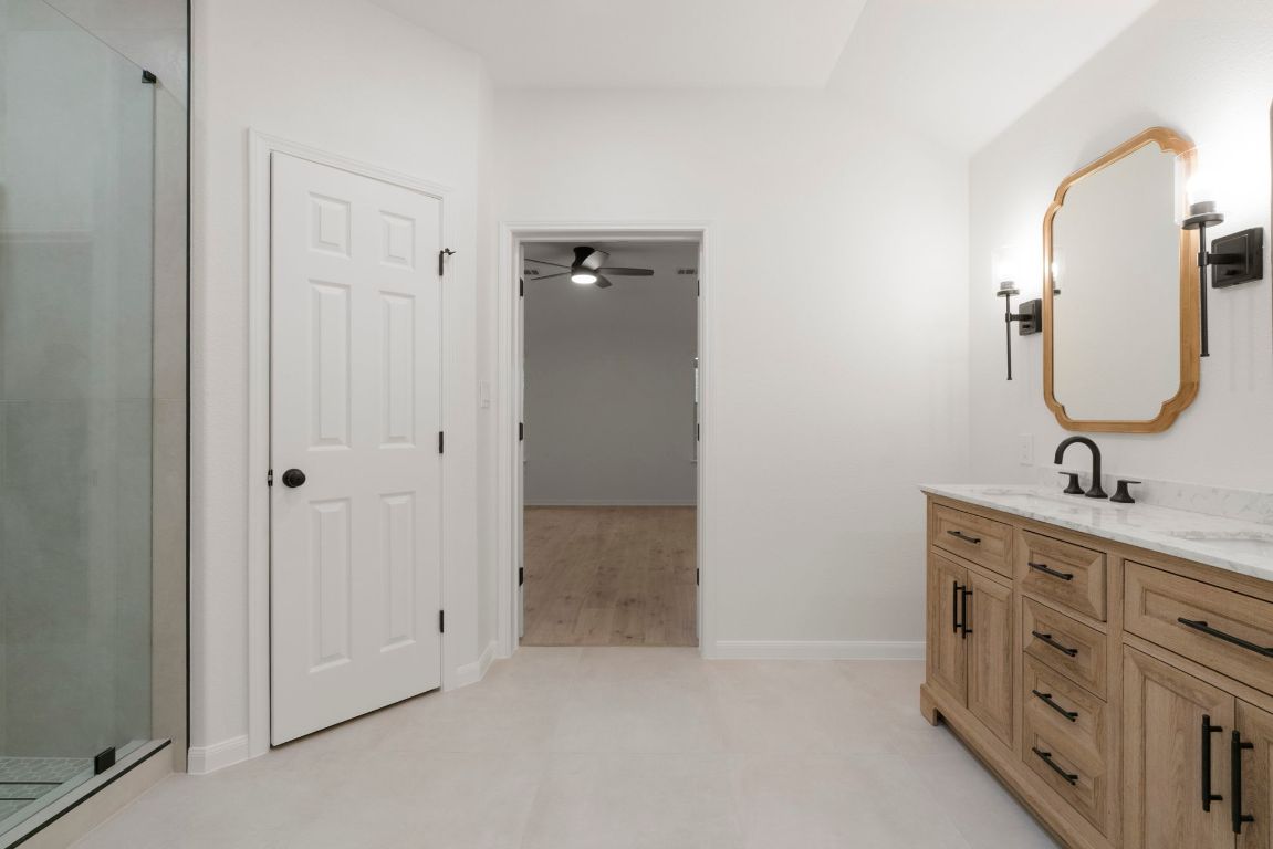 1333 Clary Sage Loop Round Rock, TX 78665 - Photo 22 of 35 a bathroom with a double vanity sink and mirror