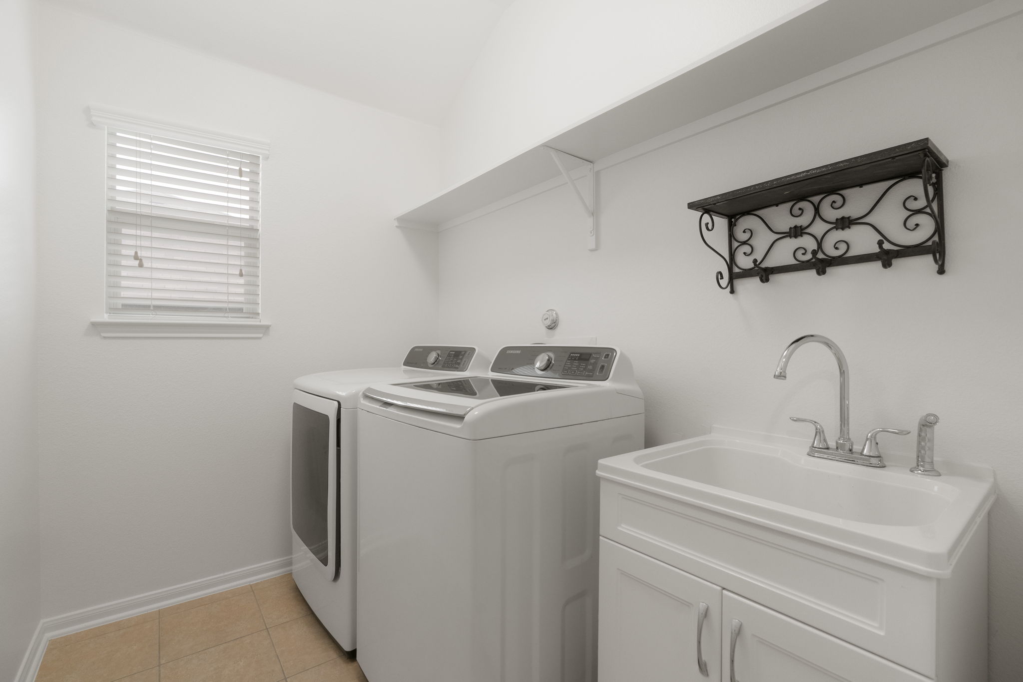 1333 Clary Sage Loop Round Rock, TX 78665 - Photo 24 of 34 Laundry room featuring light tile patterned floors, washer and clothes dryer, and cabinet space