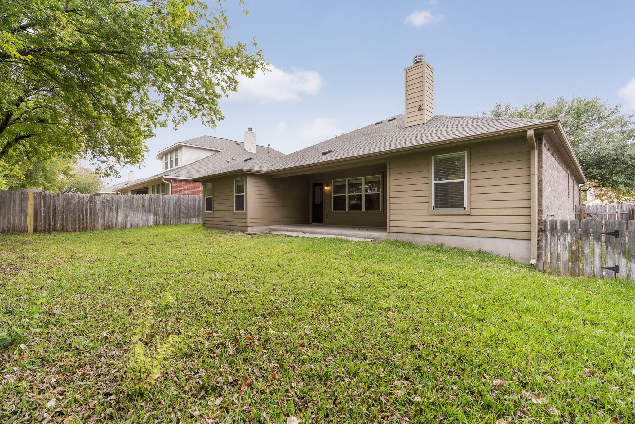 1333 Clary Sage Loop Round Rock, TX 78665 - Photo 28 of 34 Back of house featuring a patio area, a fenced backyard, a chimney, and a shingled roof