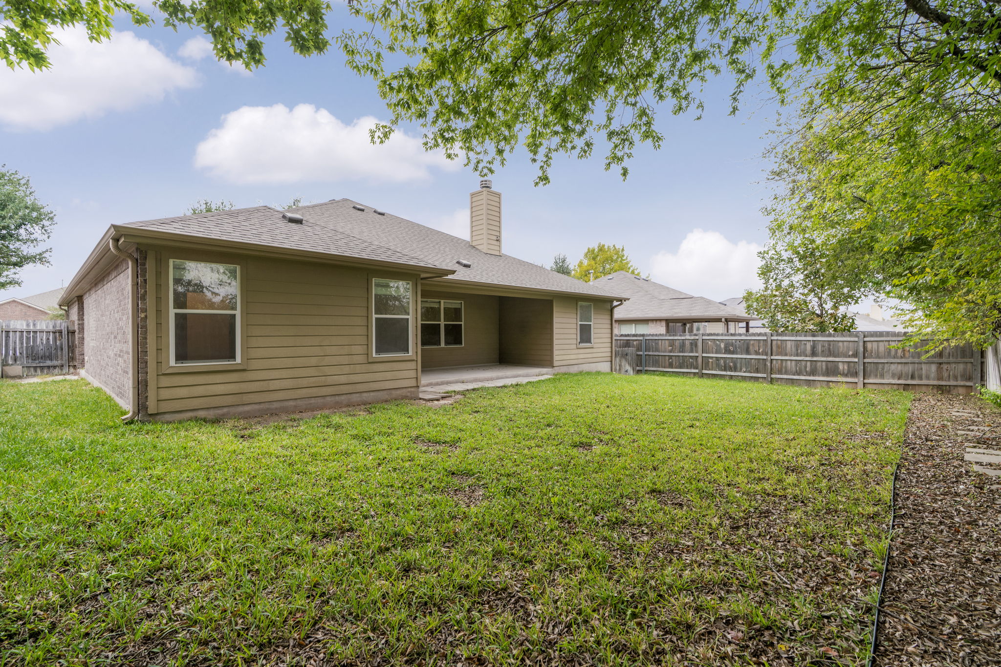 1333 Clary Sage Loop Round Rock, TX 78665 - Photo 29 of 34 Rear view of property with a patio, a fenced backyard, a chimney, and a shingled roof