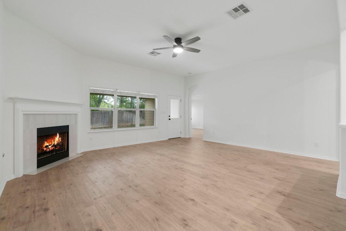 1333 Clary Sage Loop Round Rock, TX 78665 - Photo 4 of 35 a view of an empty room with a fireplace and a window