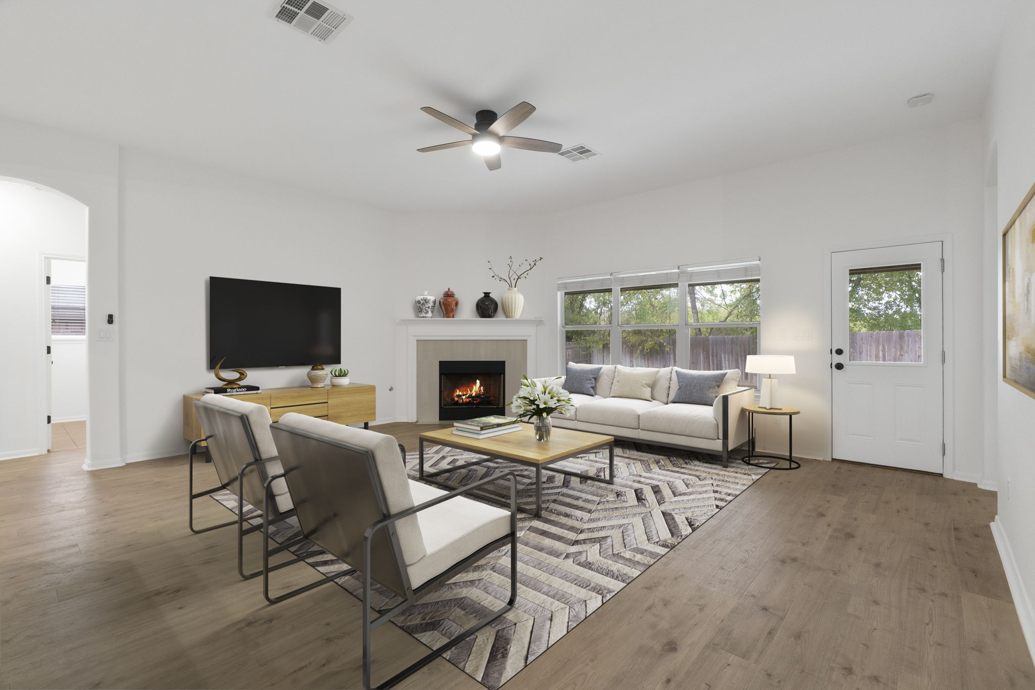 1333 Clary Sage Loop Round Rock, TX 78665 - Photo 4 of 34 Living area with arched walkways, light wood-style floors, a tiled fireplace, and ceiling fan
