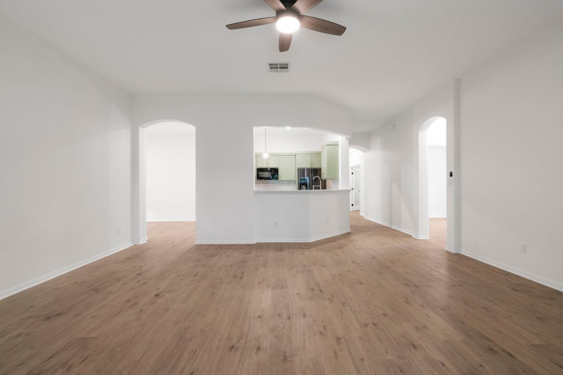 1333 Clary Sage Loop Round Rock, TX 78665 - Photo 6 of 35 a view of a livingroom with a ceiling fan window and wooden floor