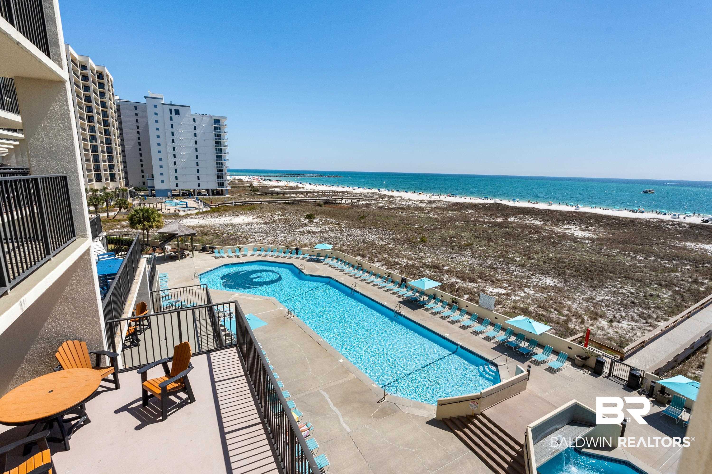26802 Perdido Beach Boulevard, Unit 406 Orange Beach, AL 36561 - Photo 2 of 37 Community pool with a jacuzzi, a patio area, view of water and beach, and a balcony