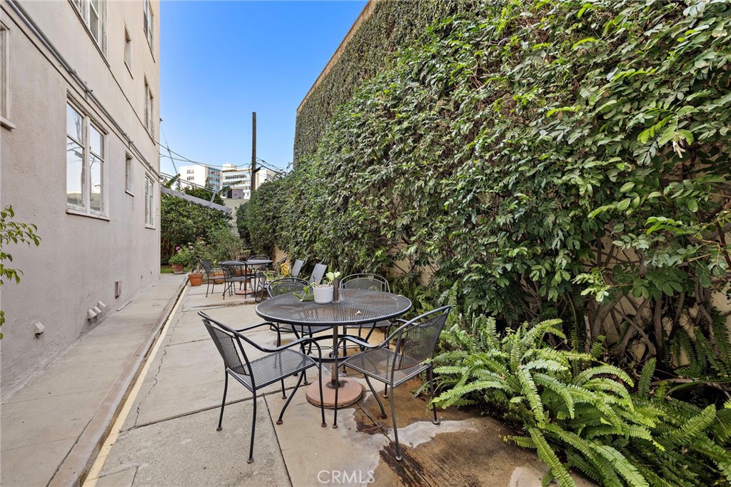 10 Atlantic Way, Unit 704 Long Beach, CA 90802 - Photo 12 of 13 a view of a backyard with table and chairs and potted plants