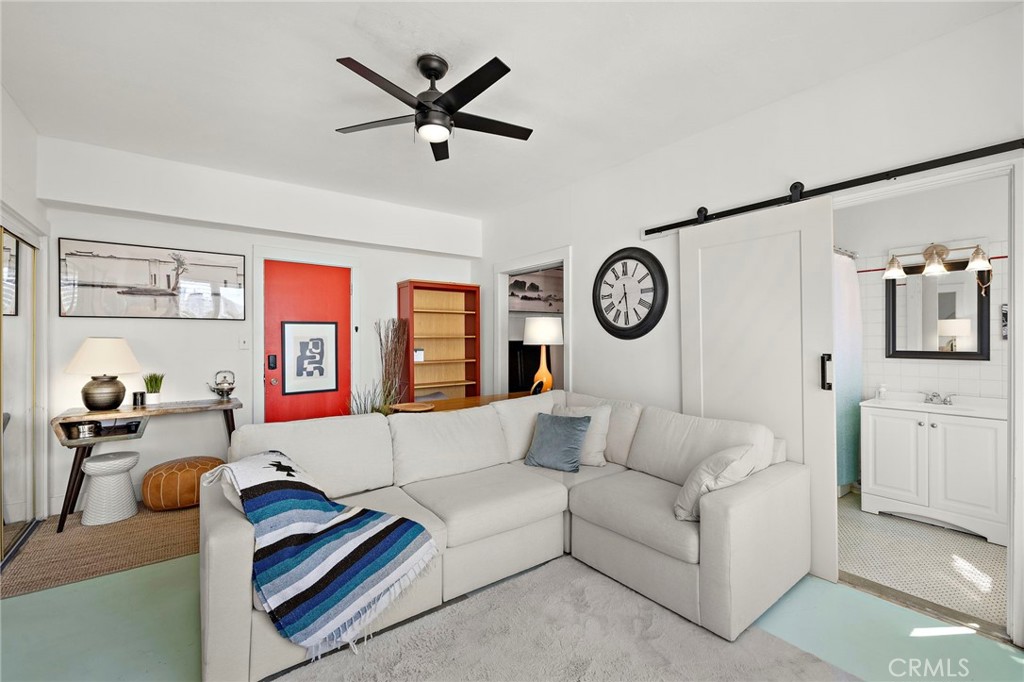 10 Atlantic Way, Unit 704 Long Beach, CA 90802 - Photo 2 of 13 a living room with furniture a clock on wall and a window