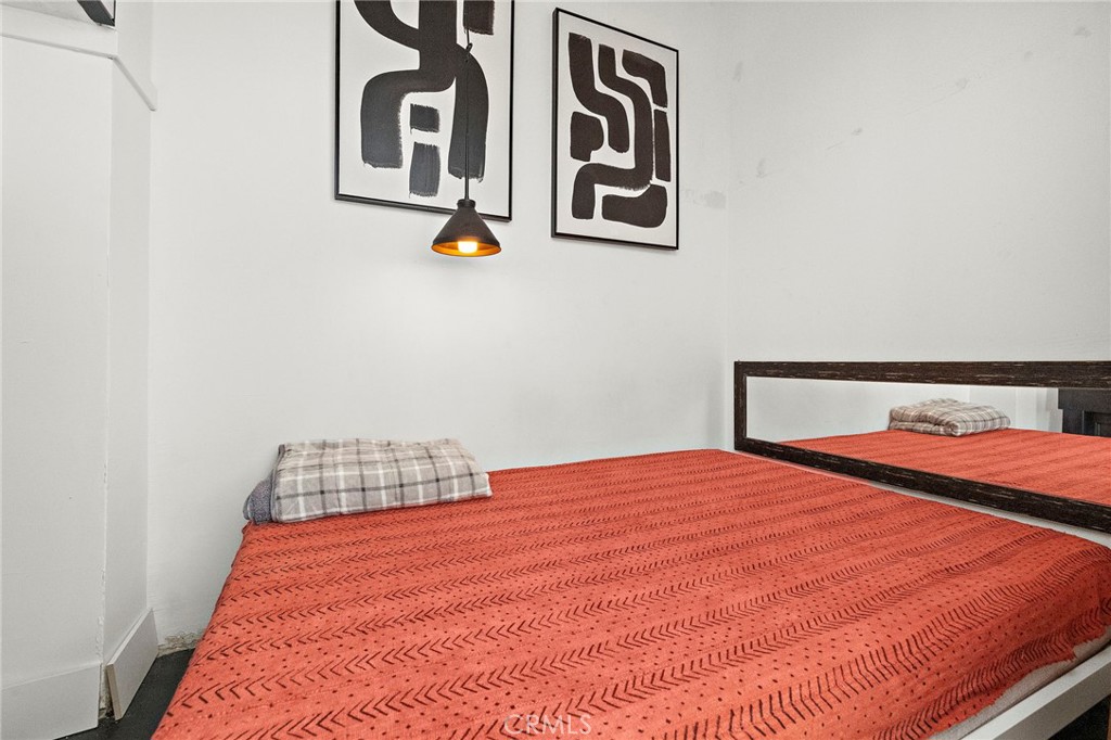 10 Atlantic Way, Unit 704 Long Beach, CA 90802 - Photo 3 of 13 a bedroom with a bed and painting on the wall
