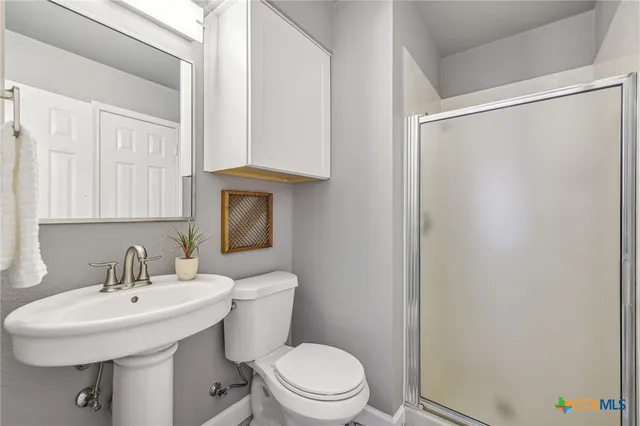 a bathroom with a sink toilet and mirror