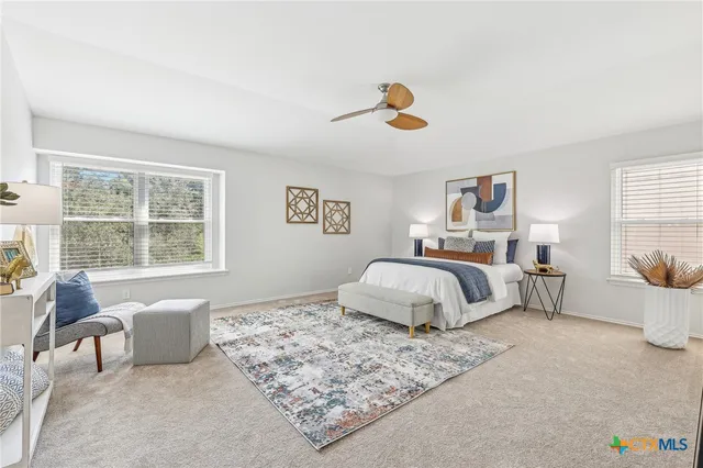 a bedroom with a large bed and a window