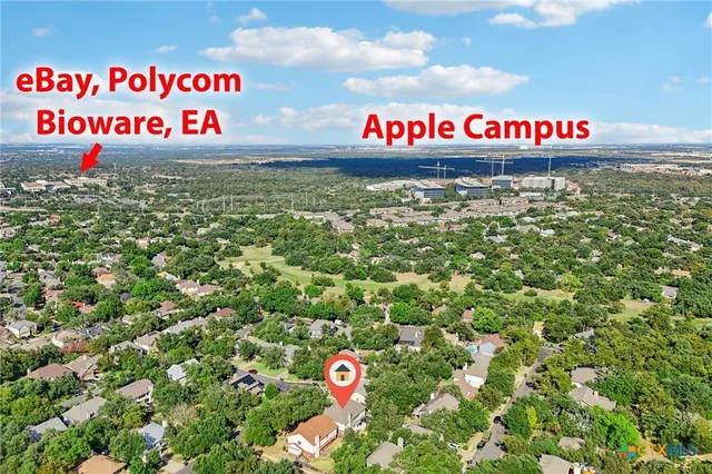 an aerial view of house with yard and mountain view in back