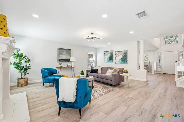 a living room with furniture and wooden floor