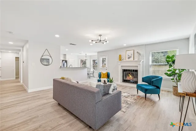 a living room with furniture a fireplace and a table