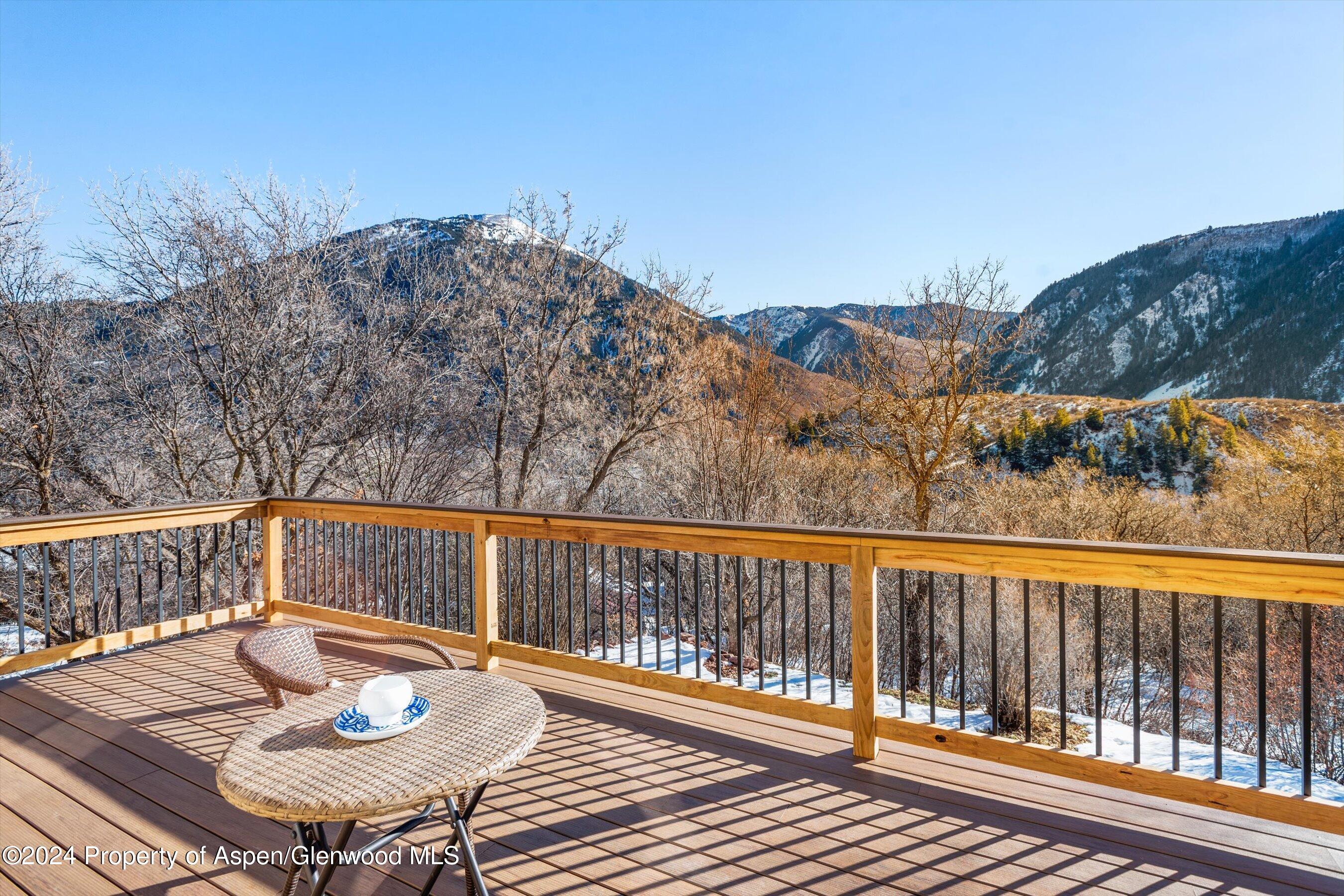 212 Cherokee Lane Carbondale, CO 81623 - Photo 15 of 34 a view of a balcony with mountain view and wooden floor