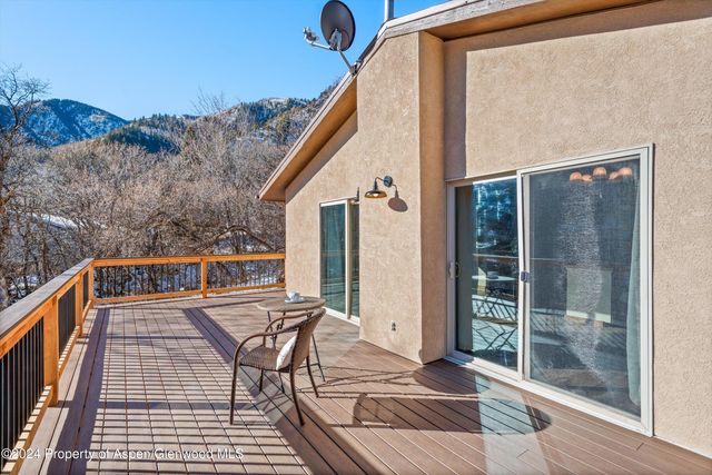 a view of balcony with wooden floor and bench