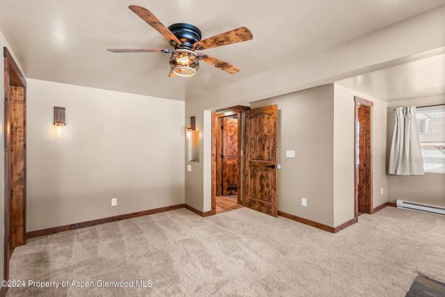 an empty room with closet and a chandelier fan