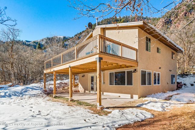 a view of a house with snow on the background