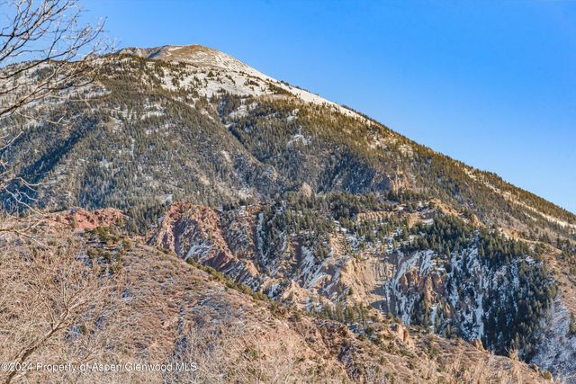 a view of a dry yard with mountains in the background