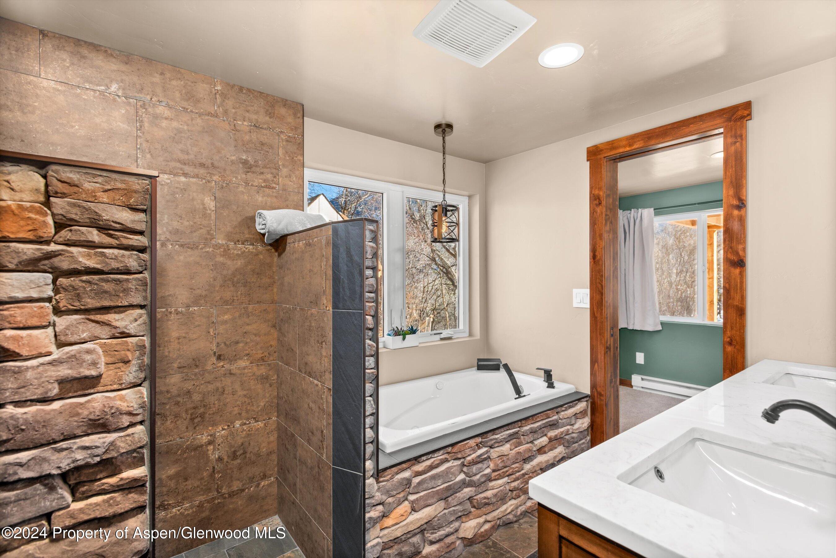 212 Cherokee Lane Carbondale, CO 81623 - Photo 4 of 34 a bathroom with a tub sink and mirror
