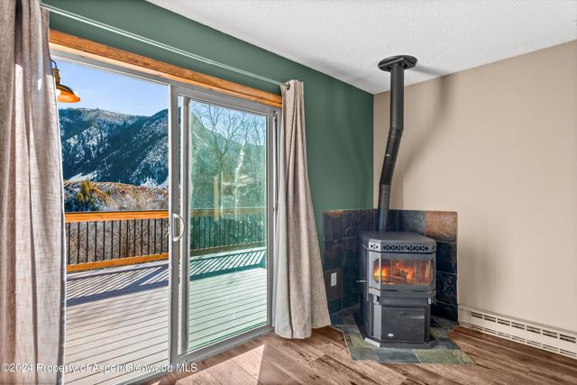 a living room with a fireplace and a floor to ceiling window