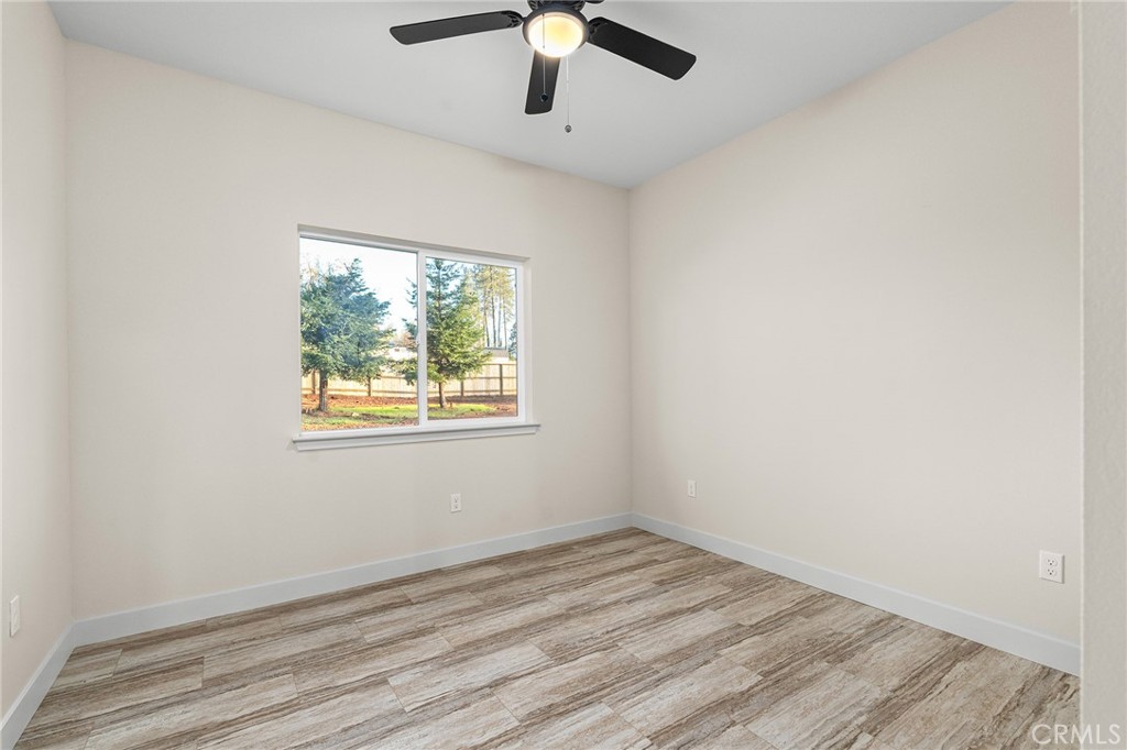 2235 Stearns Road Paradise, CA 95969 - Photo 17 of 42 an empty room with a window and a ceiling fan