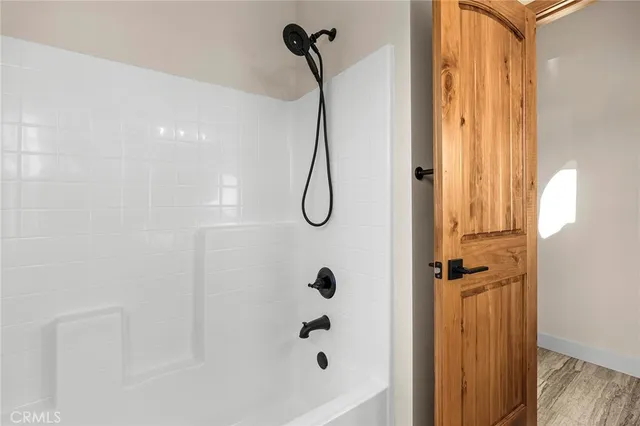 a bathroom with a glass shower door