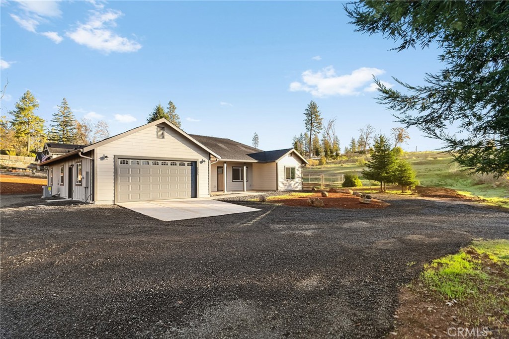 2235 Stearns Road Paradise, CA 95969 - Photo 4 of 42 a front view of a house with a yard and garage
