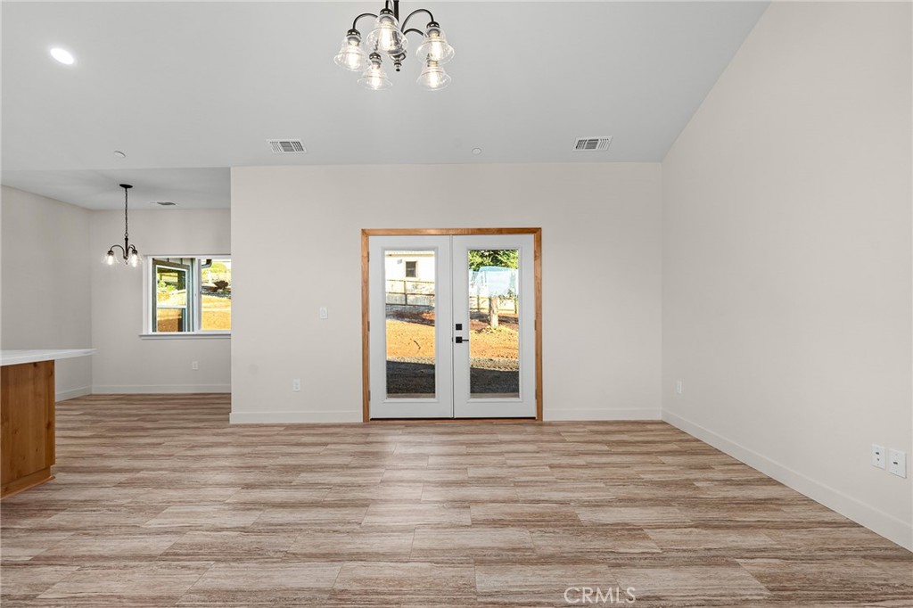 2235 Stearns Road Paradise, CA 95969 - Photo 6 of 42 a view of an empty room with wooden floor and a window