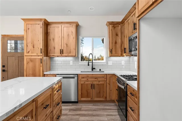 a kitchen with a sink stove and cabinets