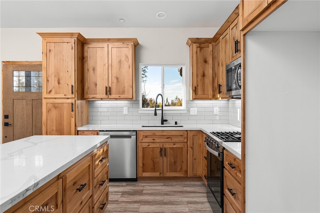 2235 Stearns Road Paradise, CA 95969 - Photo 8 of 42 a kitchen with a sink stove and cabinets