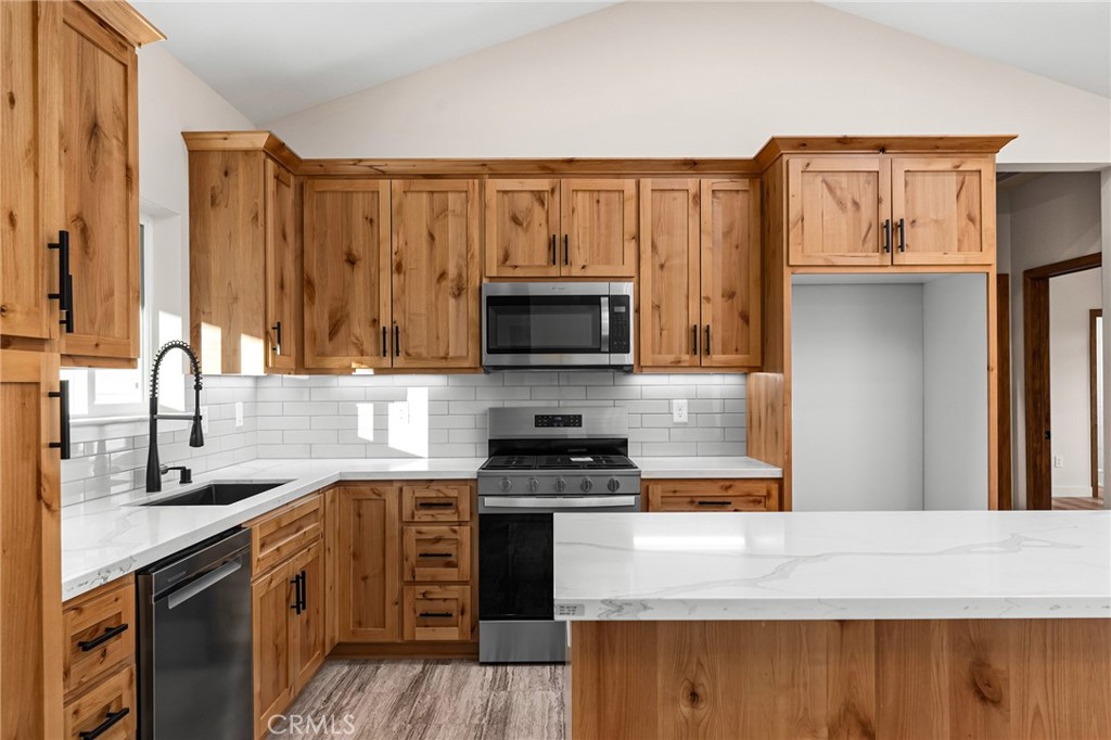 2235 Stearns Road Paradise, CA 95969 - Photo 9 of 42 a kitchen with granite countertop a stove top oven microwave and refrigerator