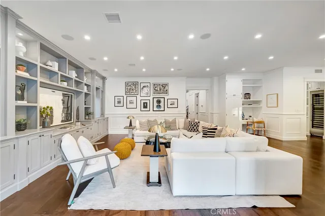 a kitchen with a sink a counter top space and a view of living room