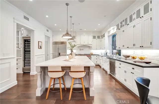 a kitchen with a stove and a white cabinets