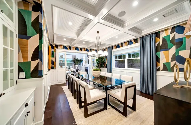 a dining room with furniture a rug and a chandelier