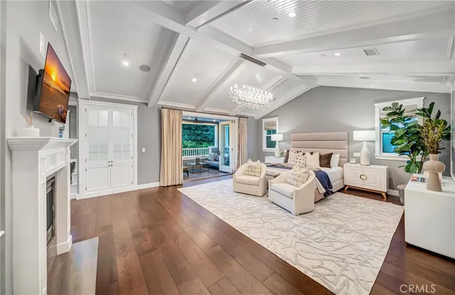 a view of a patio with table and chairs potted plants and wooden floor