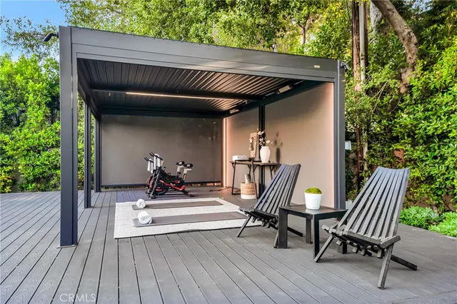 a view of a patio with table and chairs potted plants with wooden floor