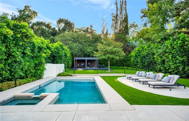 a front view of a house with a yard and trees