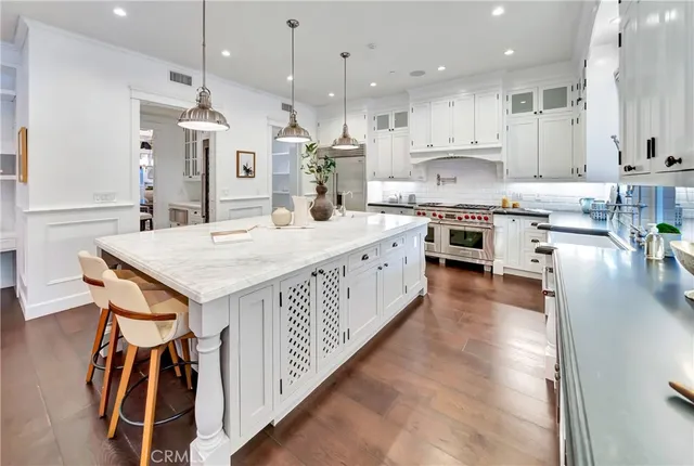 a living room with furniture a fireplace and a large mirror